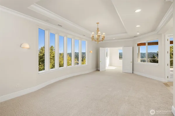 a view of an empty room with a window and fireplace