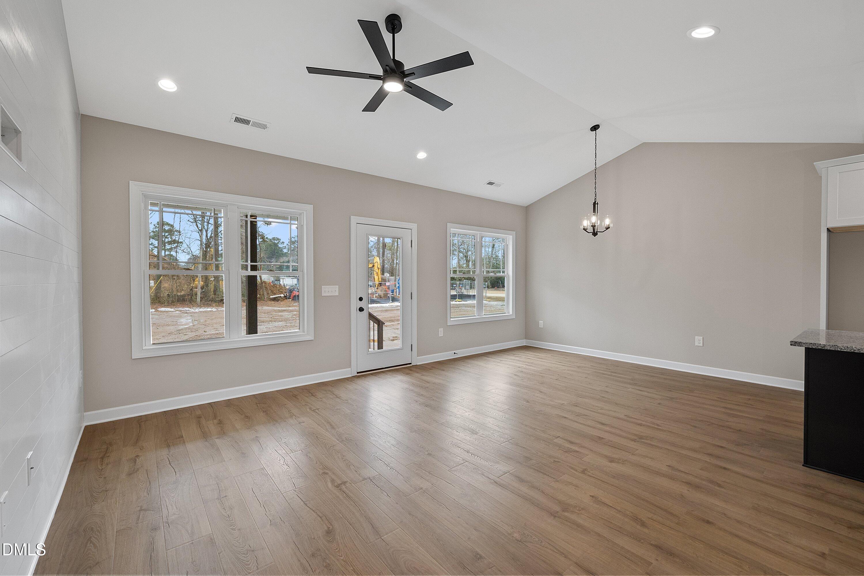 922 Micro Road West Selma, NC 27576 - Photo 13 of 36 a view of an empty room with a window and wooden floor