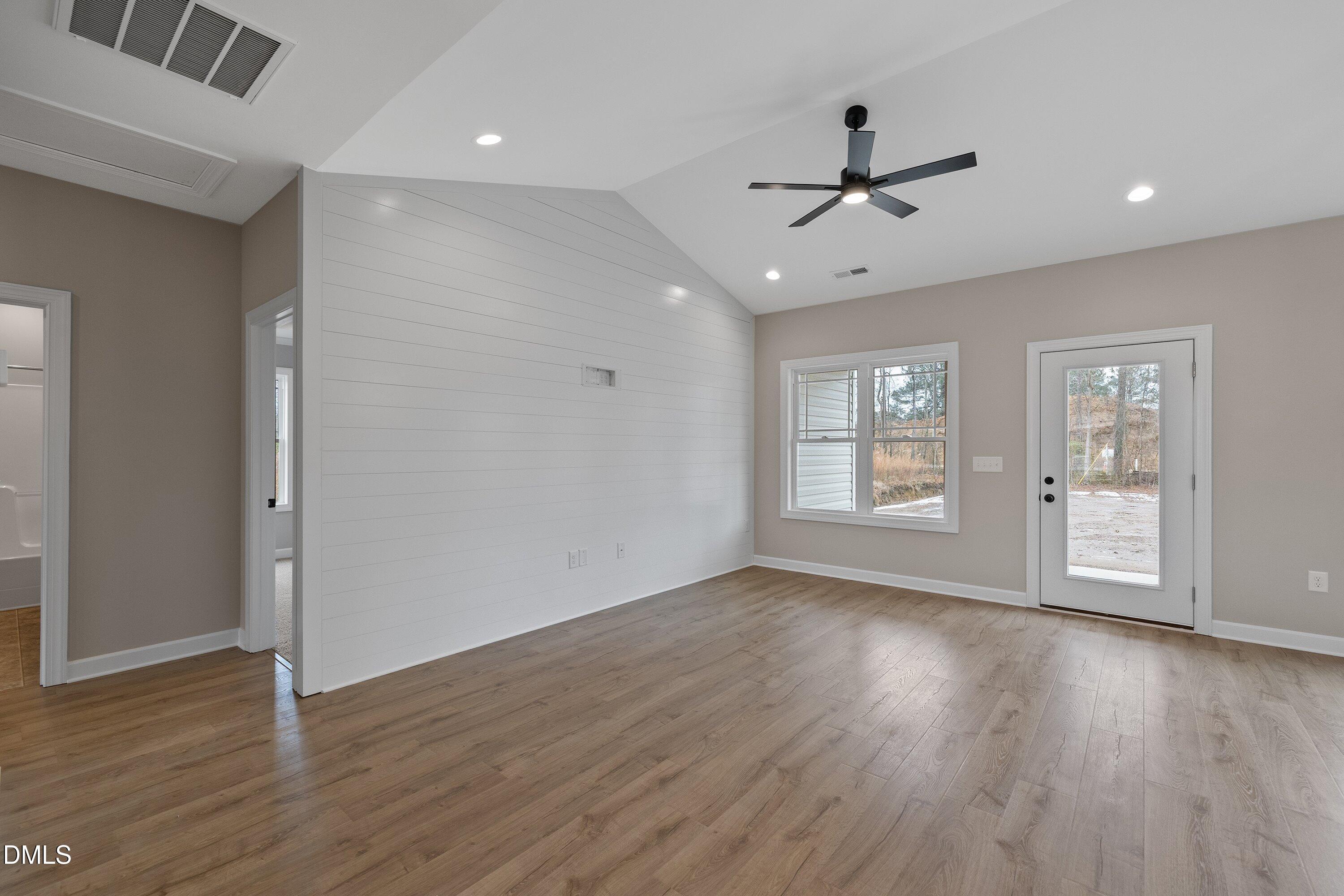 922 Micro Road West Selma, NC 27576 - Photo 14 of 36 a view of an empty room with wooden floor and a window