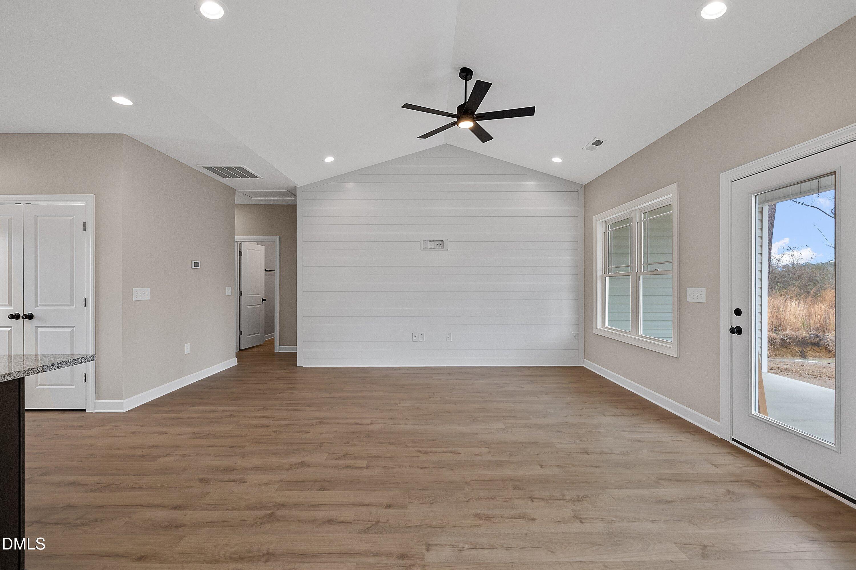 922 Micro Road West Selma, NC 27576 - Photo 15 of 36 a view of empty room with wooden floor and fan
