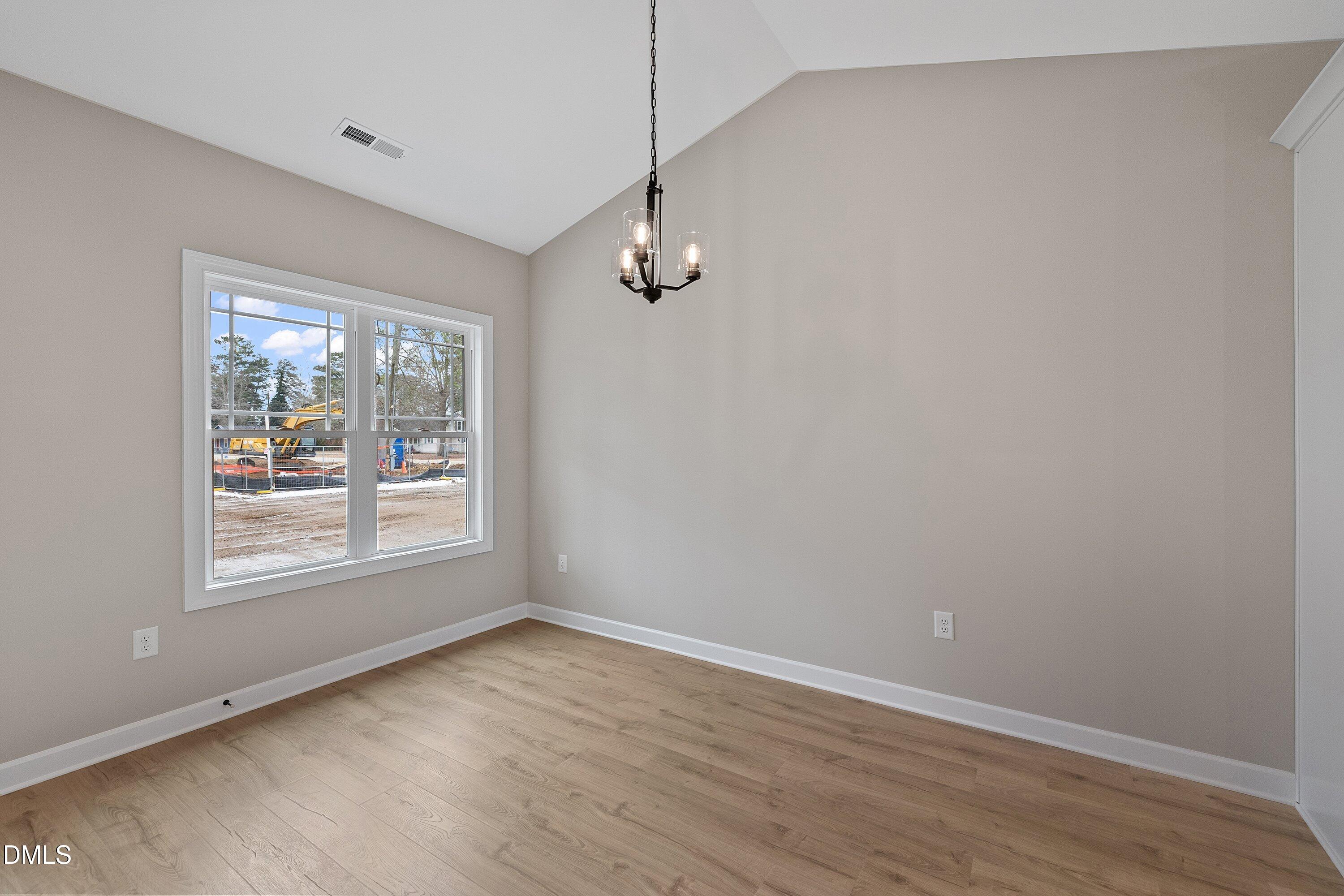 922 Micro Road West Selma, NC 27576 - Photo 18 of 36 wooden floor in an empty room with a window