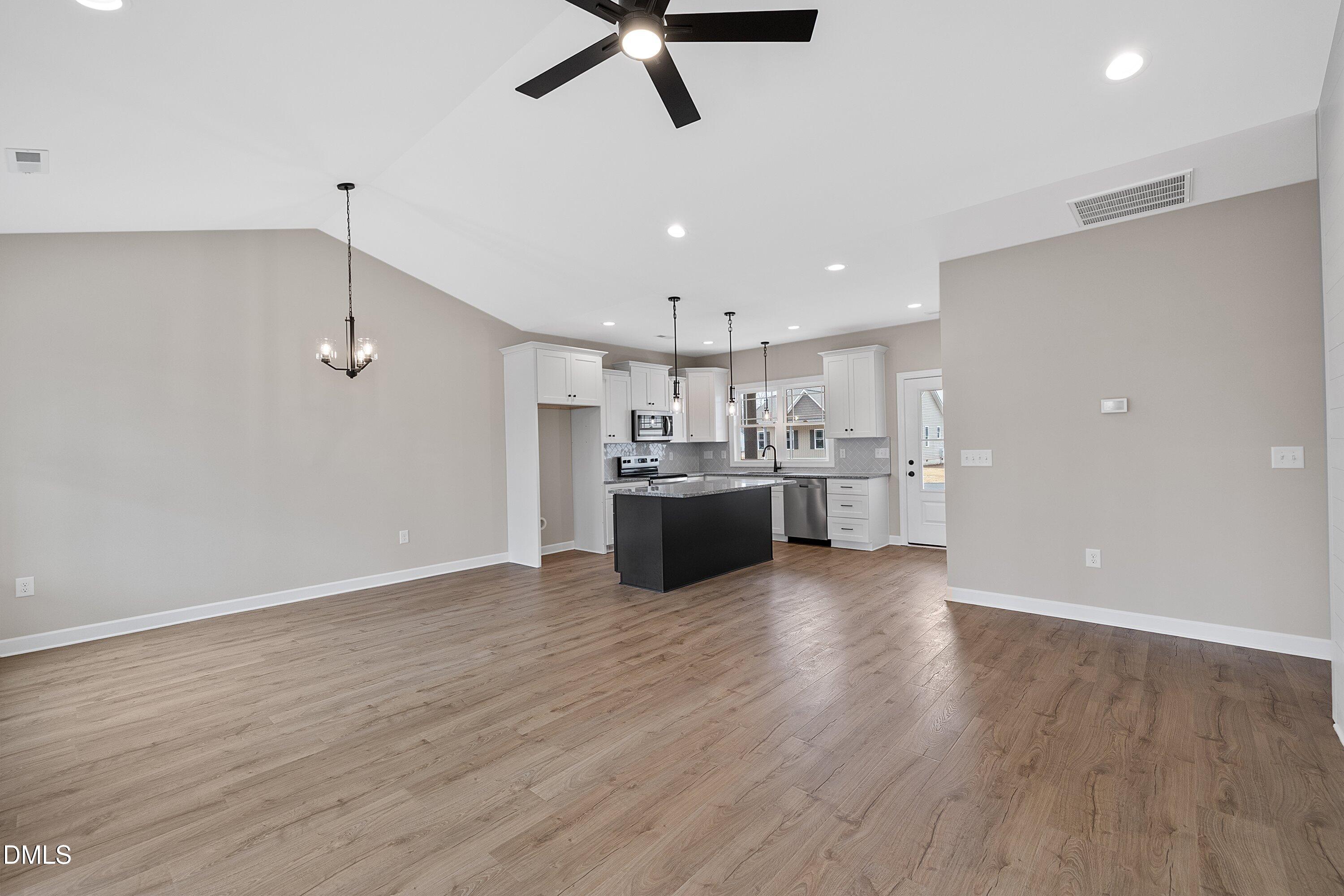 922 Micro Road West Selma, NC 27576 - Photo 19 of 36 a view of kitchen and kitchen with stainless steel appliances wooden floor