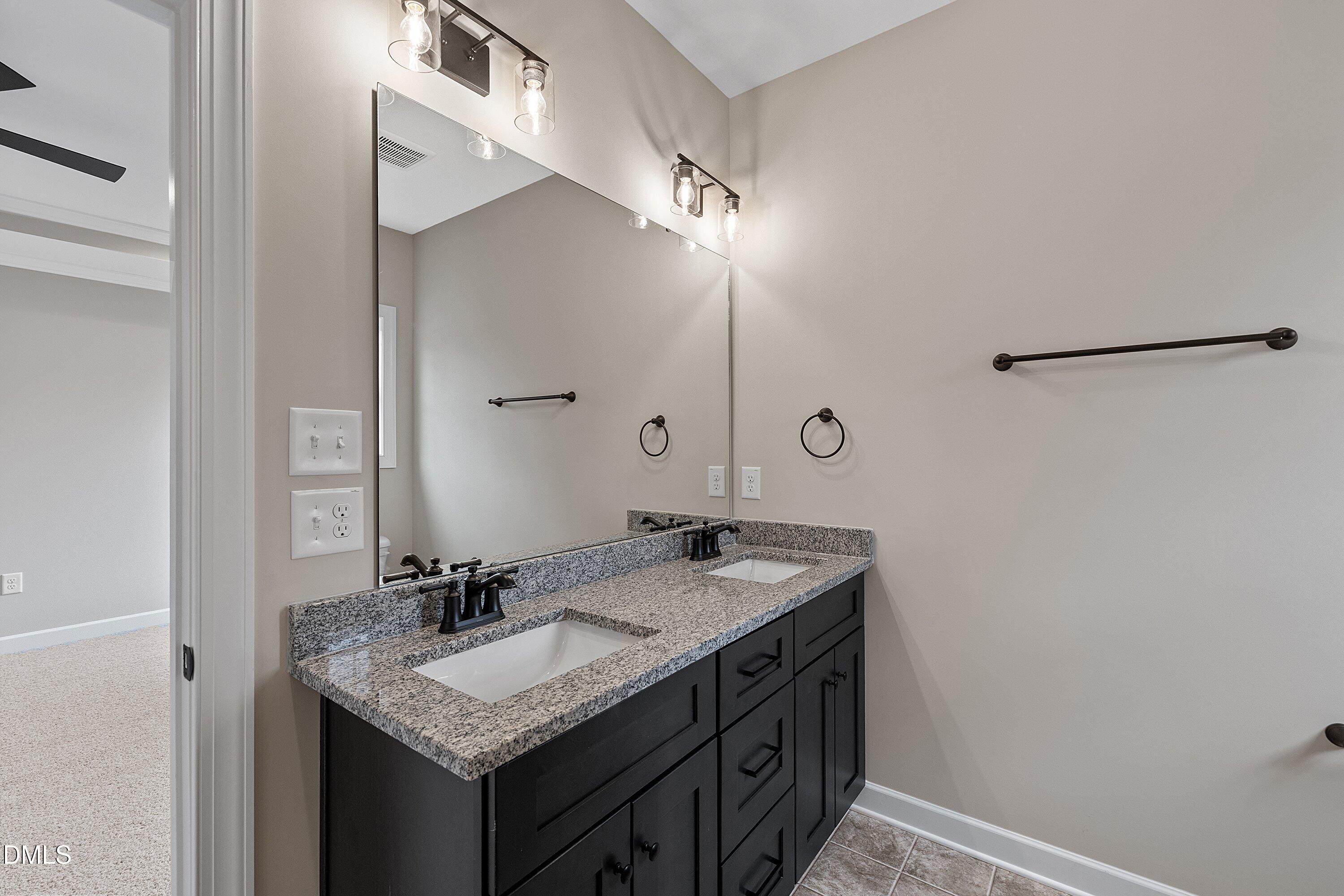 922 Micro Road West Selma, NC 27576 - Photo 26 of 36 a bathroom with a granite countertop sink and a mirror