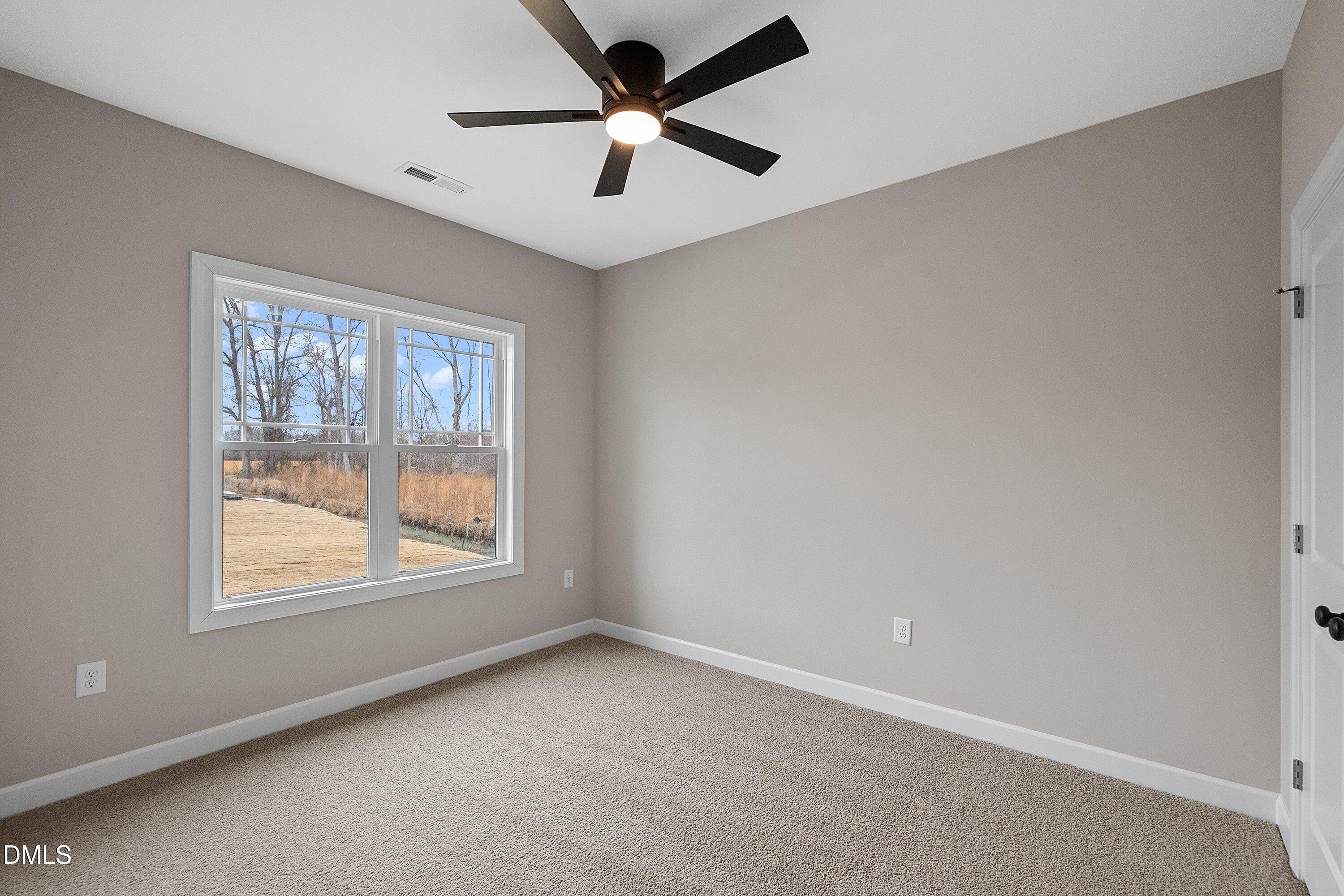 922 Micro Road West Selma, NC 27576 - Photo 29 of 36 an empty room with a window and a fan