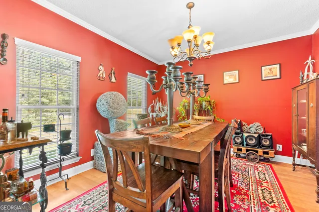 a view of a dining room with furniture and chandelier