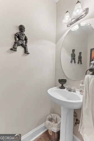 a bathroom with a sink a toilet and mirror