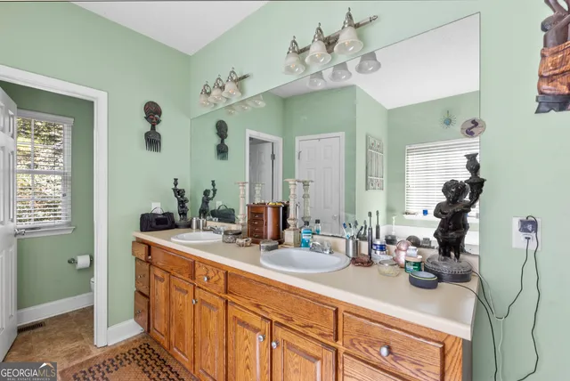 a bathroom with a sink double vanity and a mirror
