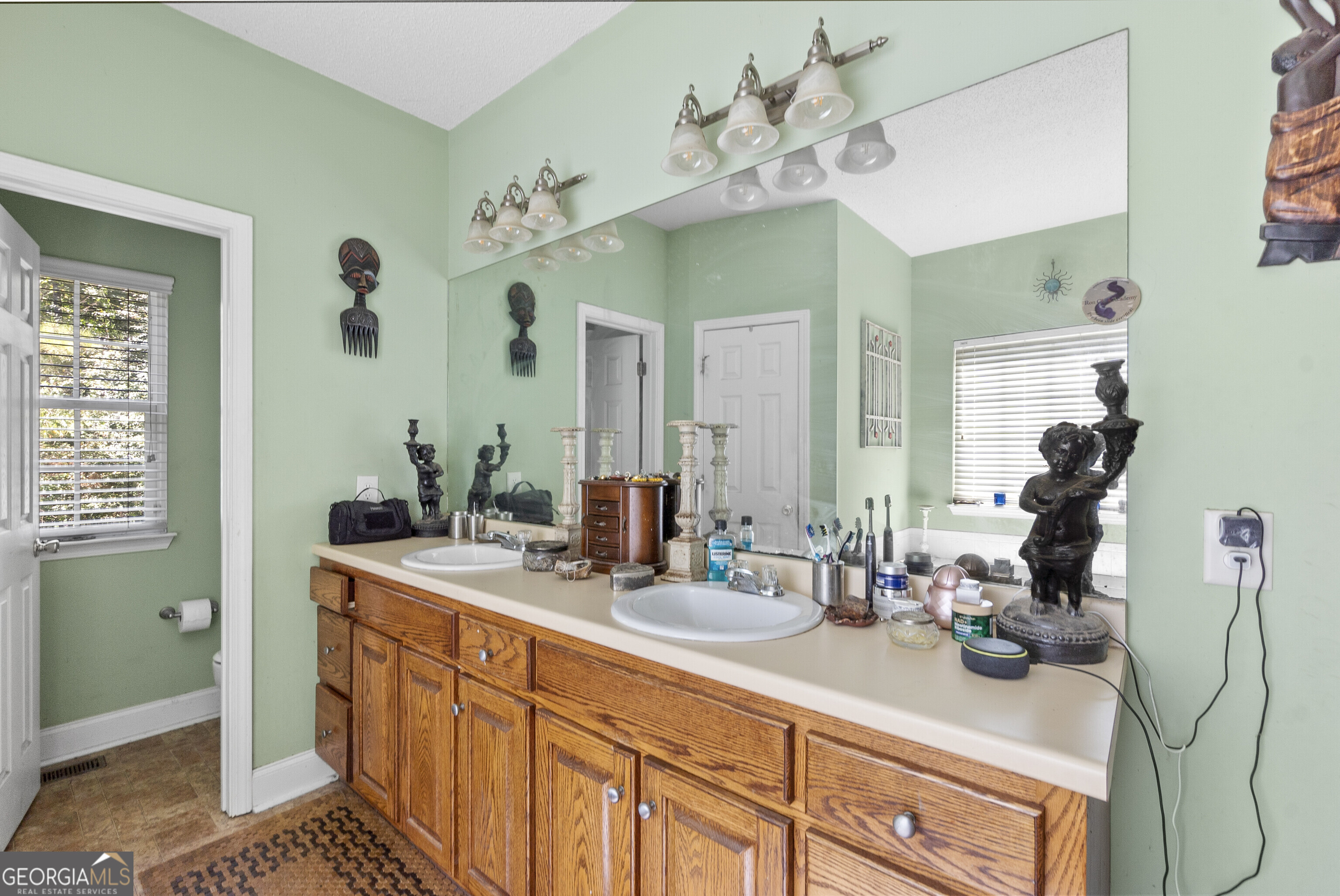 3608 Joycliff Road Macon, GA 31211 - Photo 20 of 44 a bathroom with a sink double vanity and a mirror