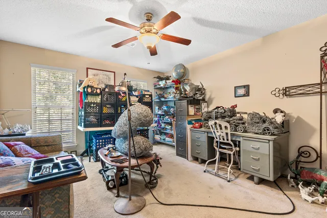 a view of a workspace with furniture and toys