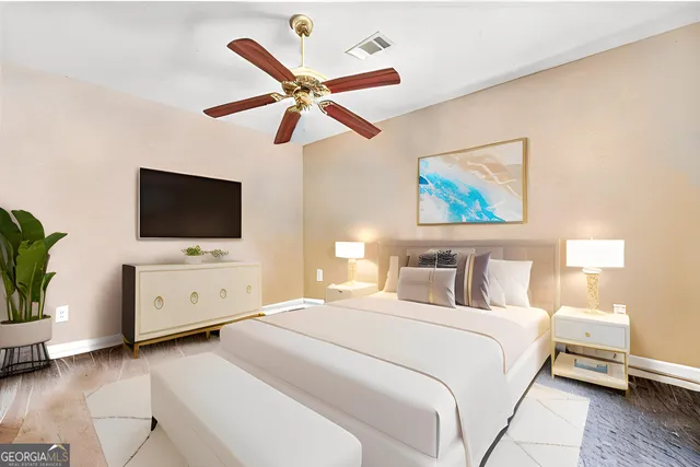 a bedroom with a large bed and a flat screen tv