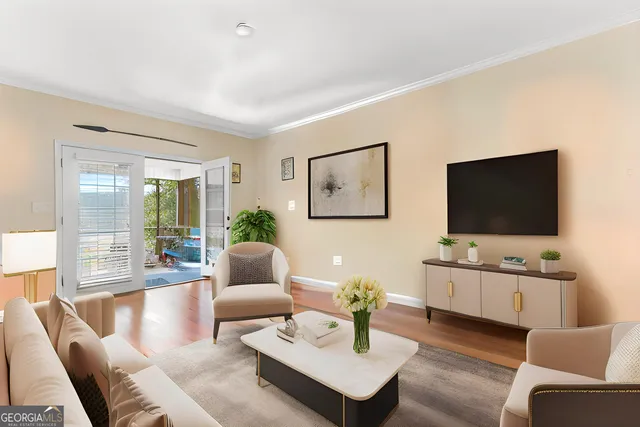a living room with furniture and a flat screen tv