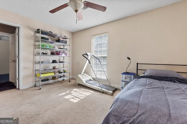a bedroom with bed and a book shelf