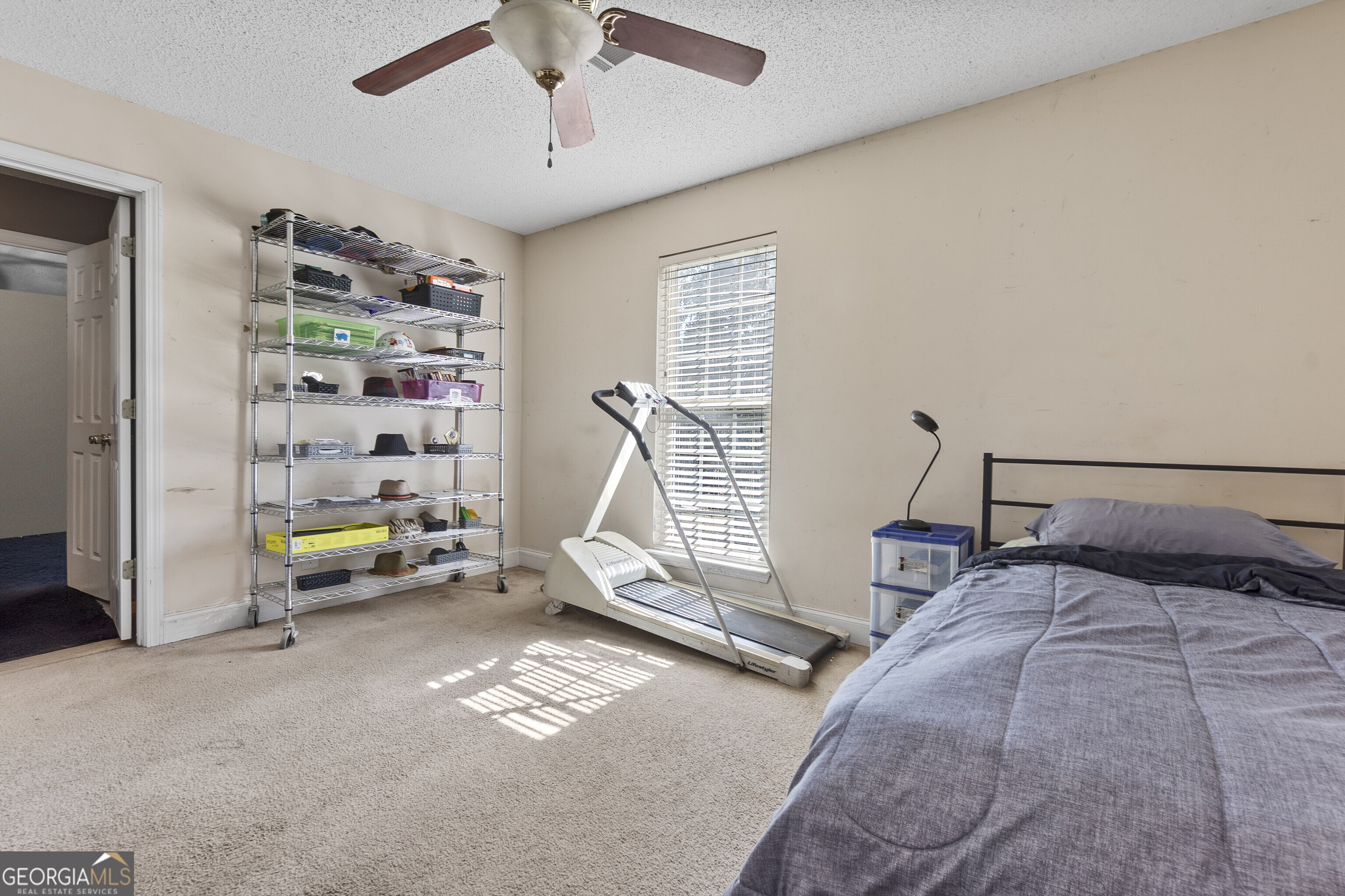 3608 Joycliff Road Macon, GA 31211 - Photo 33 of 44 a bedroom with bed and a book shelf