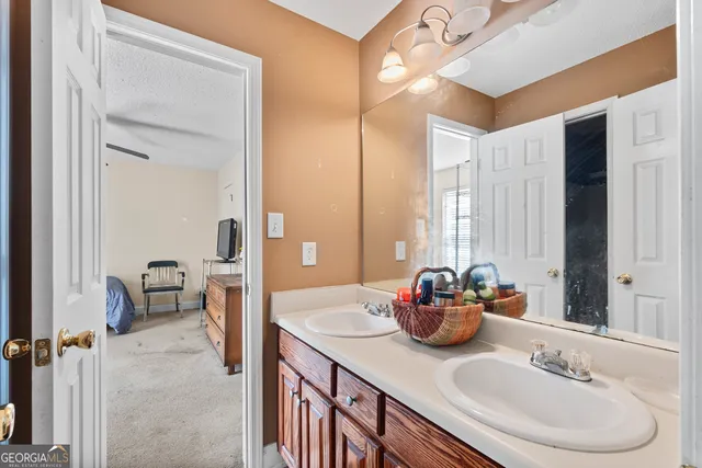 a bathroom with a sink double vanity and a mirror