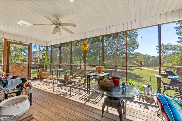a living room with furniture and floor to ceiling windows
