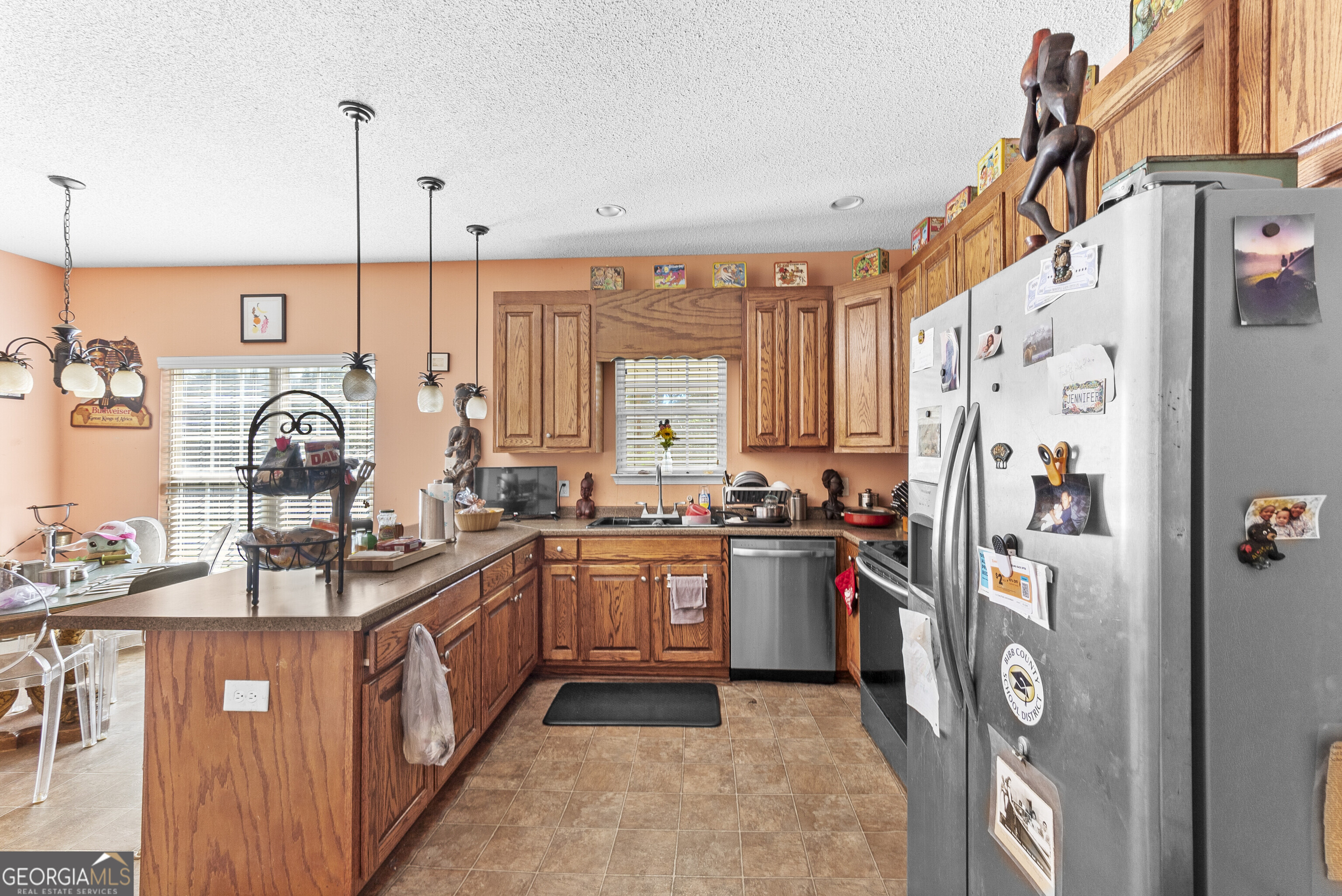 3608 Joycliff Road Macon, GA 31211 - Photo 7 of 44 a kitchen with stainless steel appliances granite countertop a sink stove and refrigerator