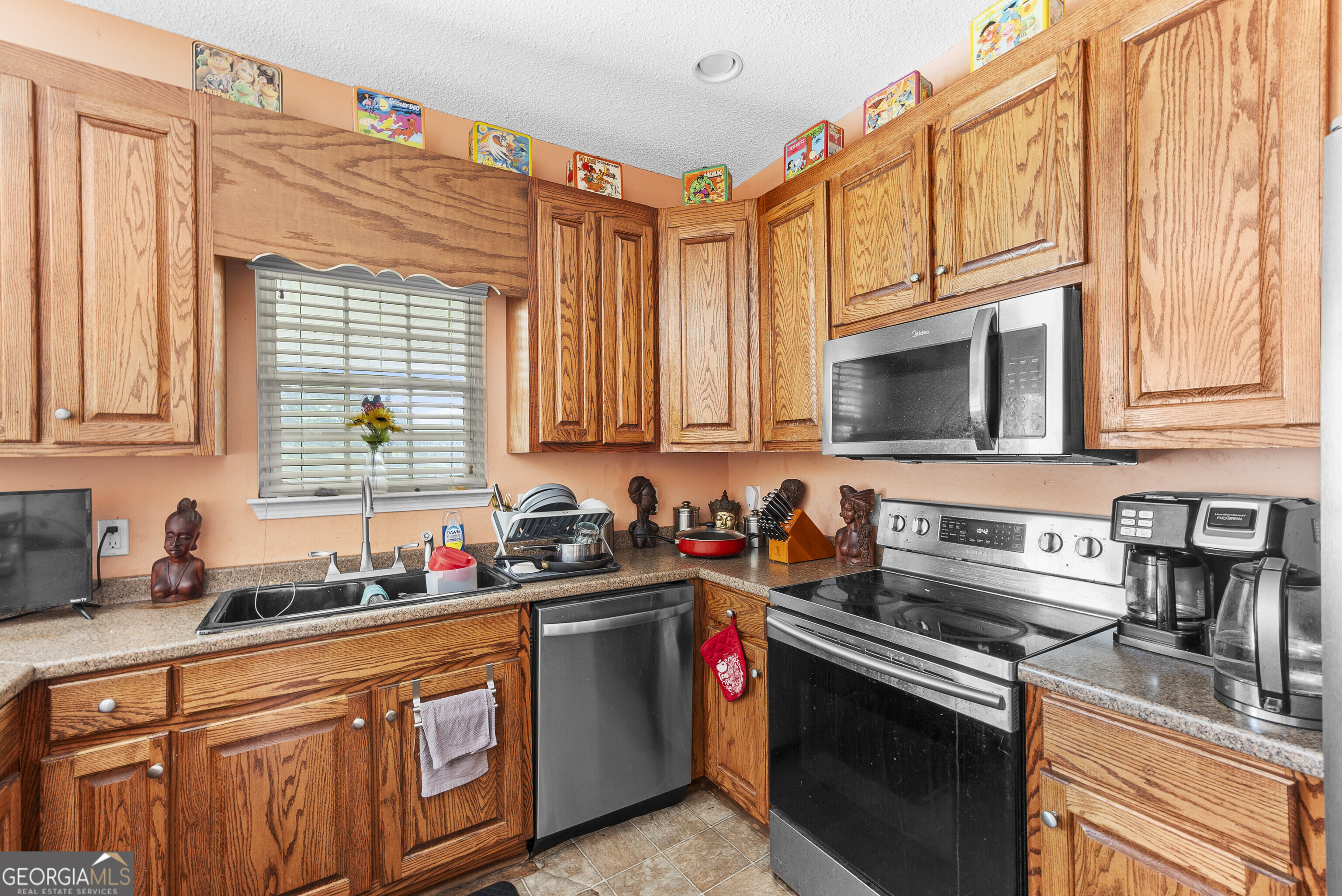 3608 Joycliff Road Macon, GA 31211 - Photo 8 of 44 a kitchen with stainless steel appliances granite countertop a sink stove and microwave