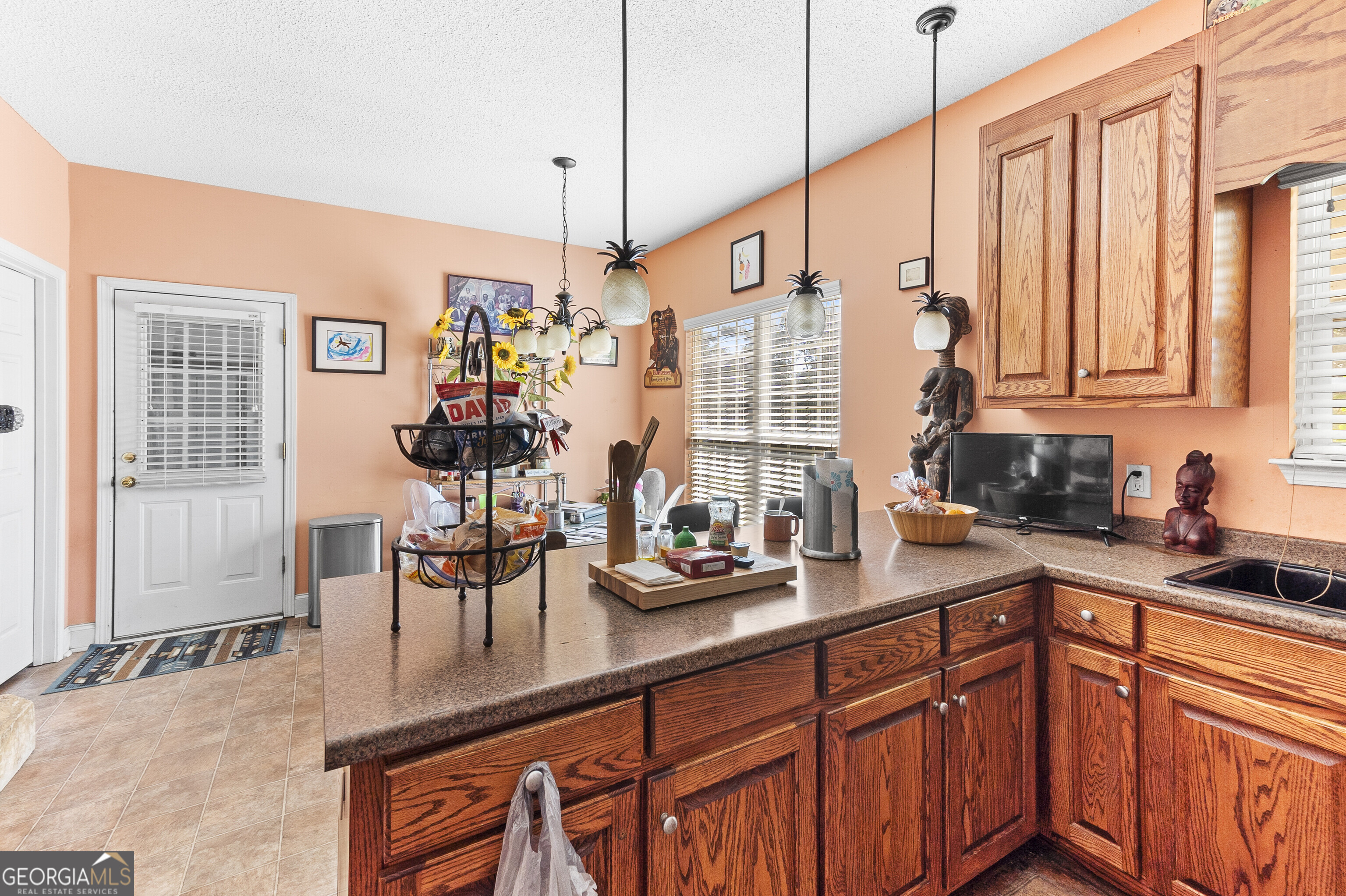 3608 Joycliff Road Macon, GA 31211 - Photo 9 of 44 a kitchen with stainless steel appliances granite countertop a sink a stove and a wooden cabinets