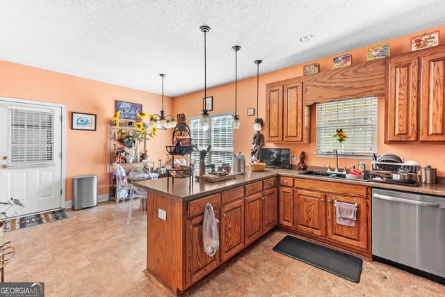 a kitchen with stainless steel appliances granite countertop a sink and cabinets