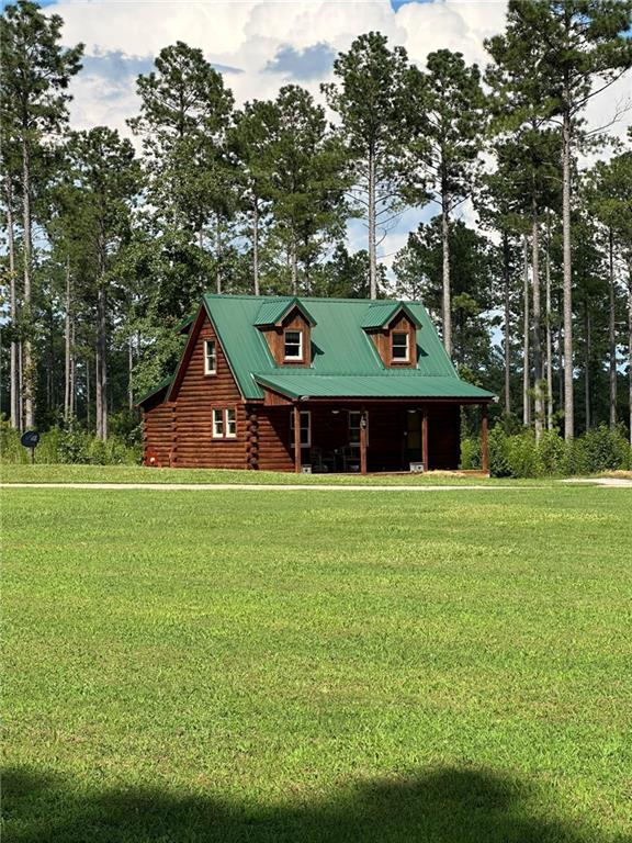 2470 Fears Road Madison, GA 30650 - Photo 25 of 48 a front view of a house with a garden