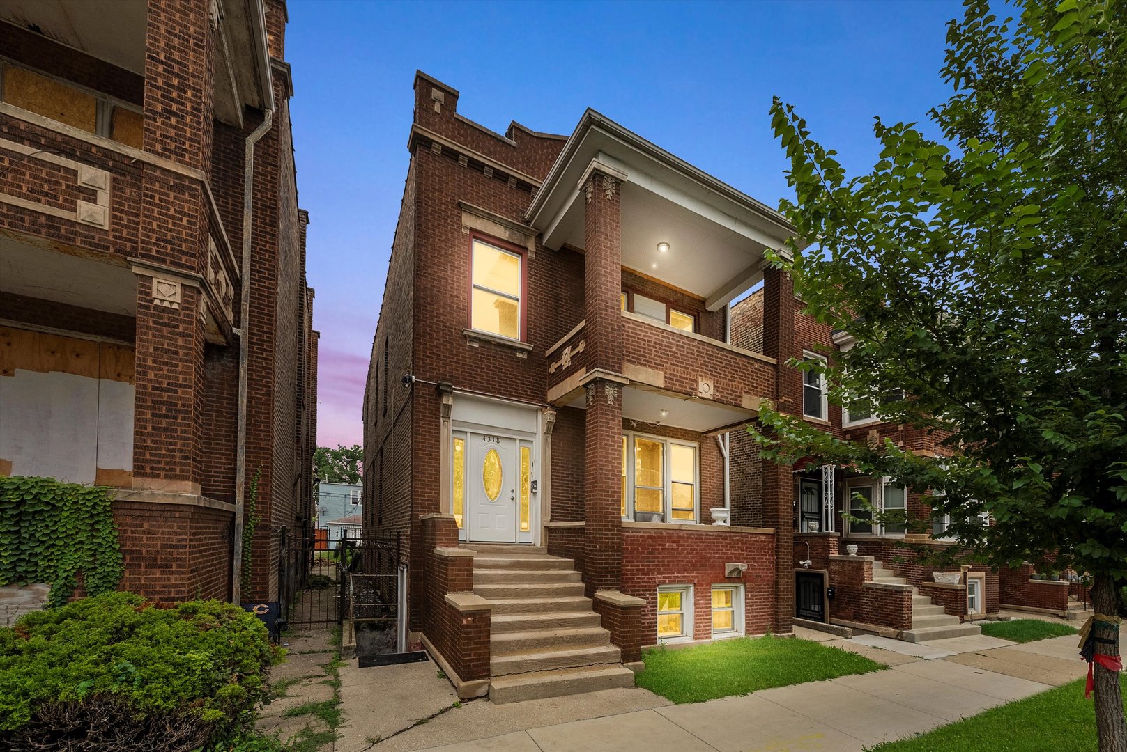 4318 West Cermak Road Chicago, IL 60623 - Photo 1 of 17 a front view of a house with a yard