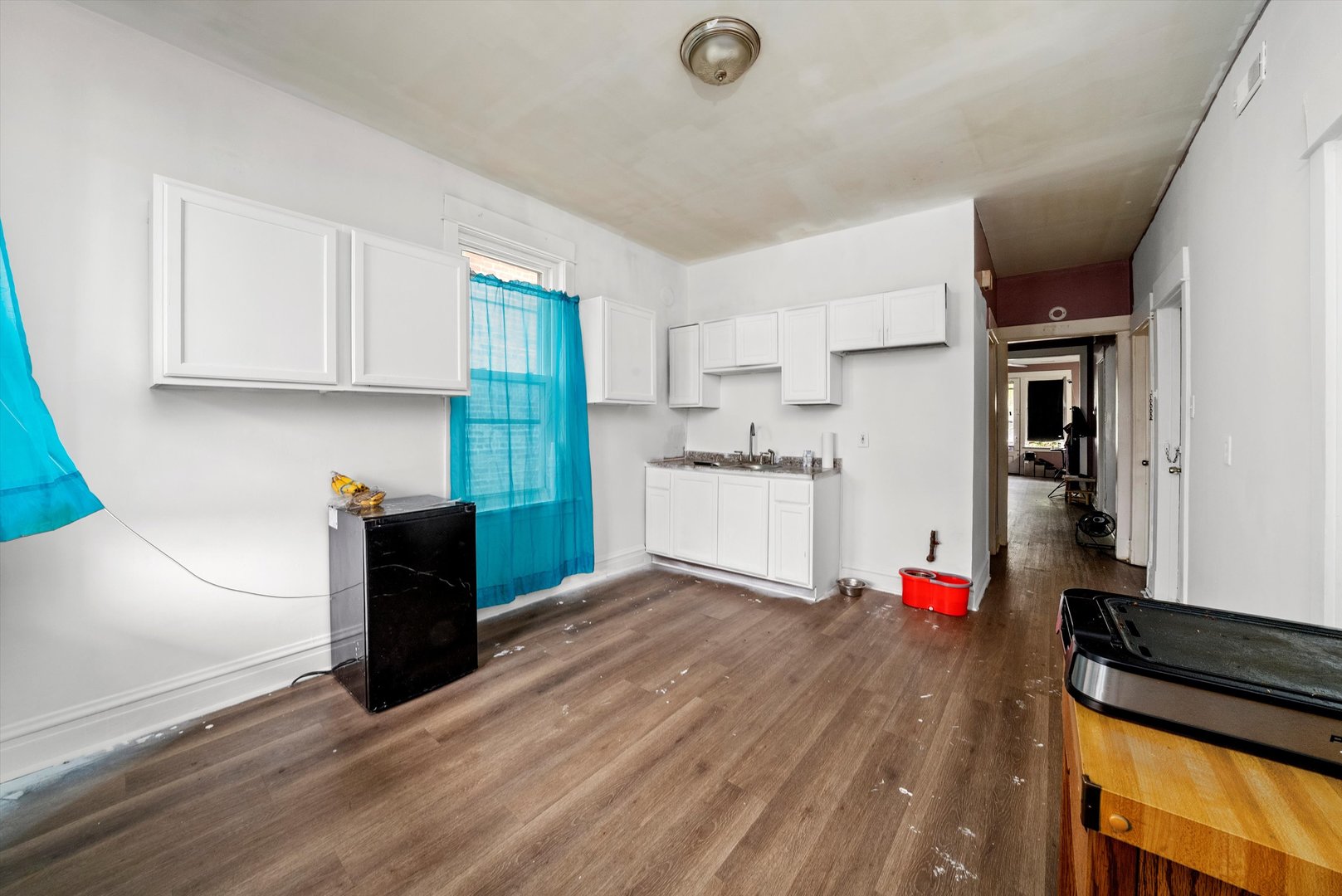 4318 West Cermak Road Chicago, IL 60623 - Photo 12 of 17 a kitchen with stainless steel appliances granite countertop a refrigerator and a stove top oven