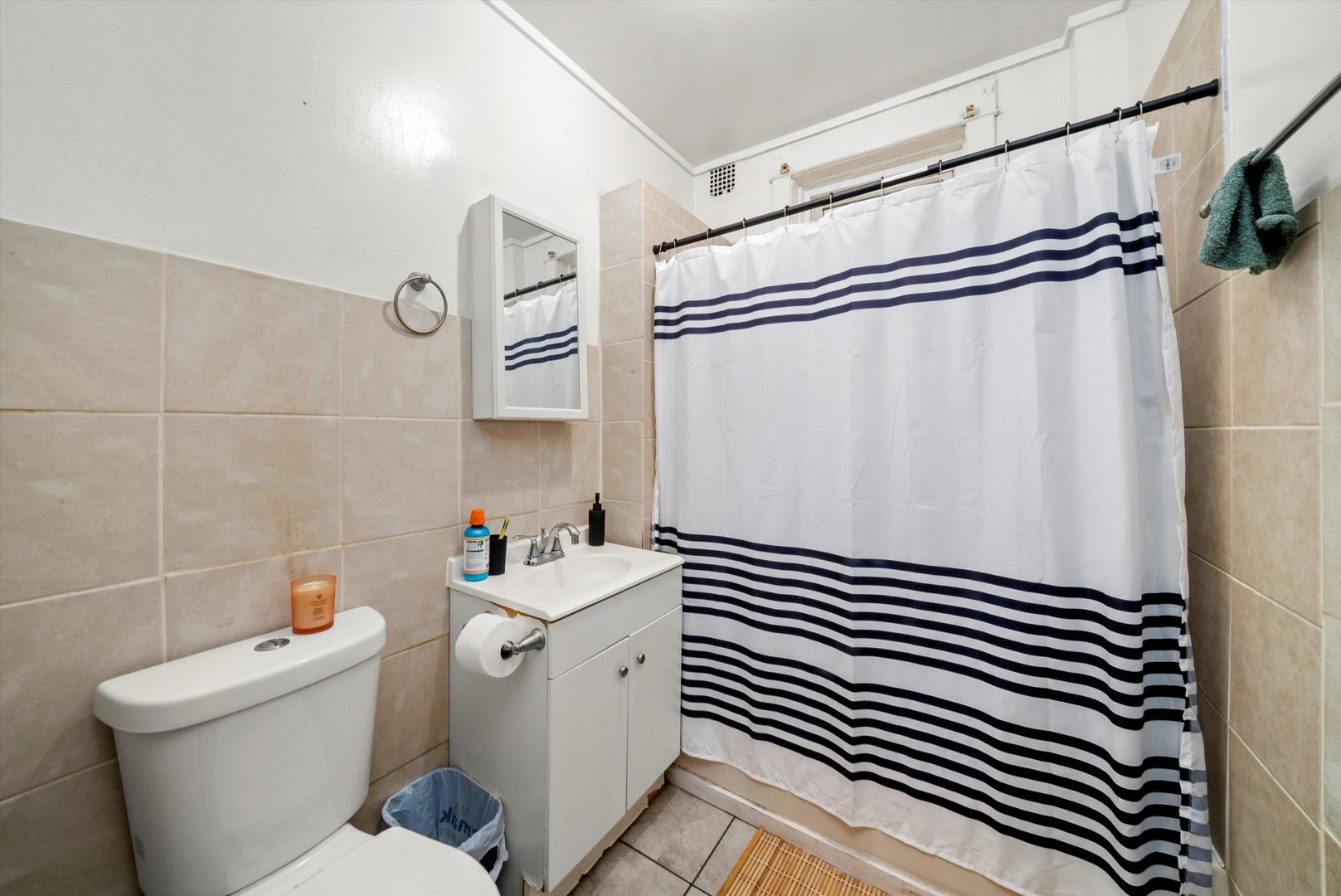 4318 West Cermak Road Chicago, IL 60623 - Photo 13 of 17 a bathroom with a sink a toilet and shower curtain