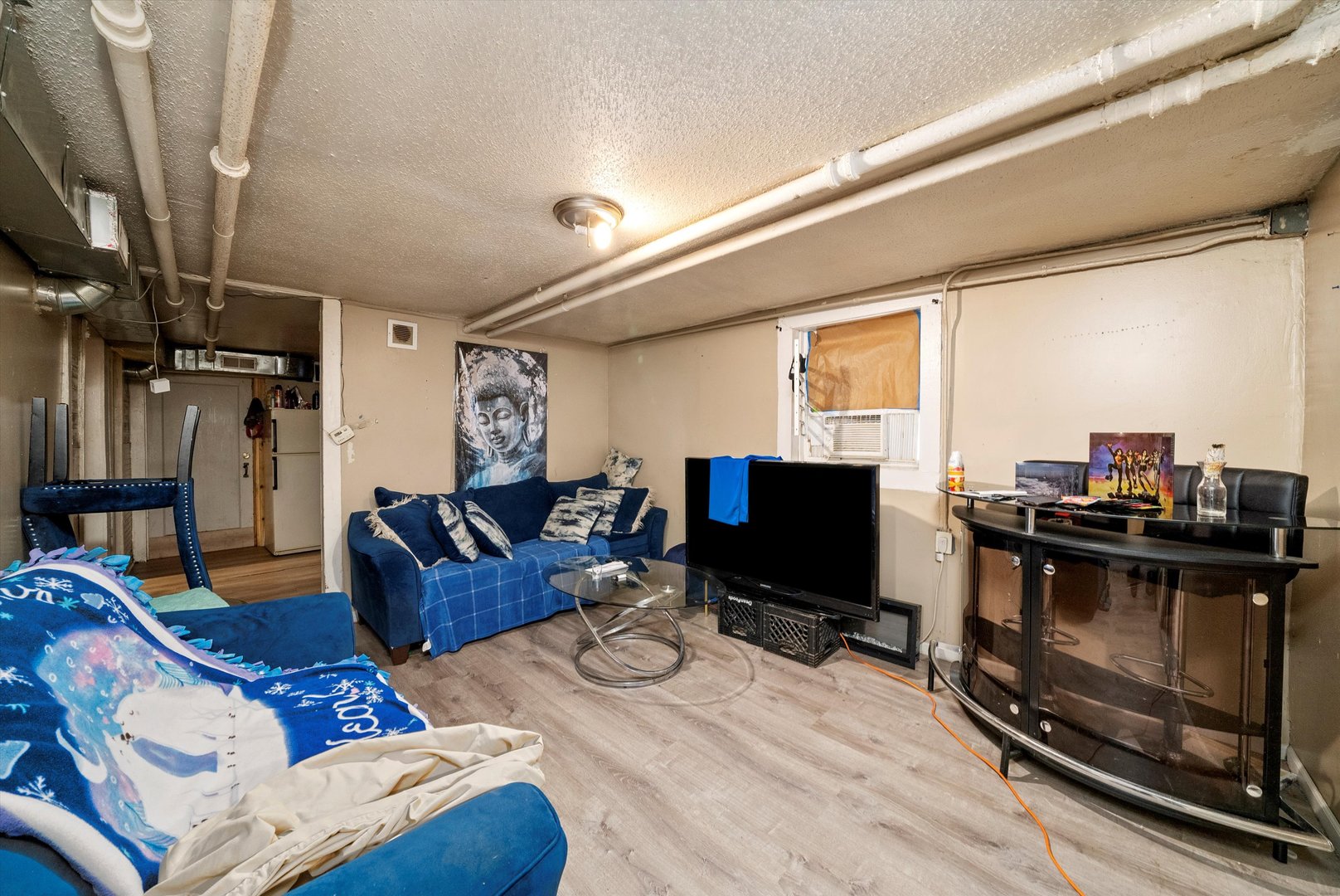 4318 West Cermak Road Chicago, IL 60623 - Photo 15 of 17 a living room with furniture and a flat screen tv