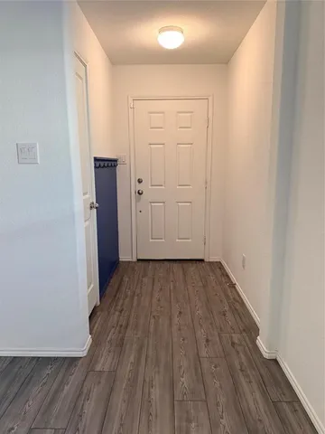 an empty room with wooden floor and closet
