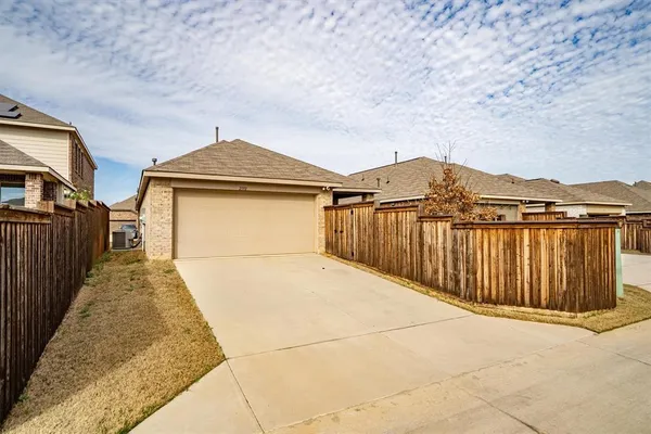 a view of a house with wooden fence