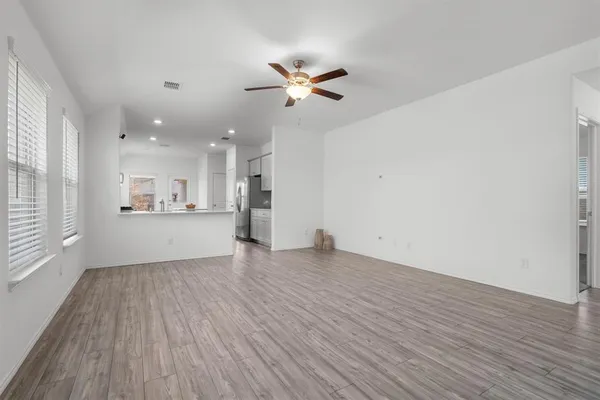 a view of a kitchen with wooden floor and a kitchen