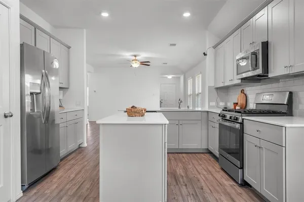 a kitchen with a sink stainless steel appliances and cabinets
