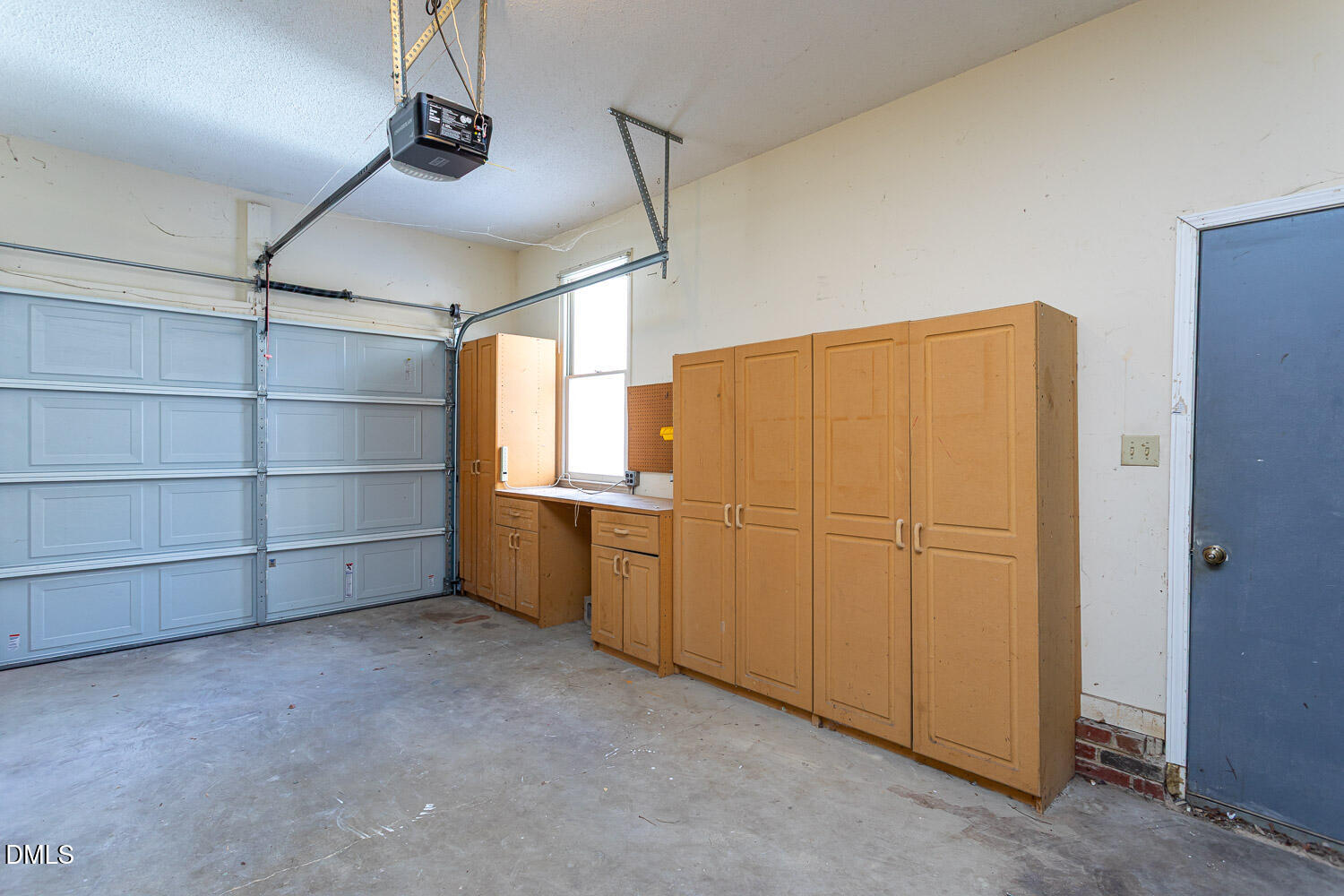 10609 Orchid Lane Raleigh, NC 27603 - Photo 22 of 27 One car garage with built ins and extra shelving