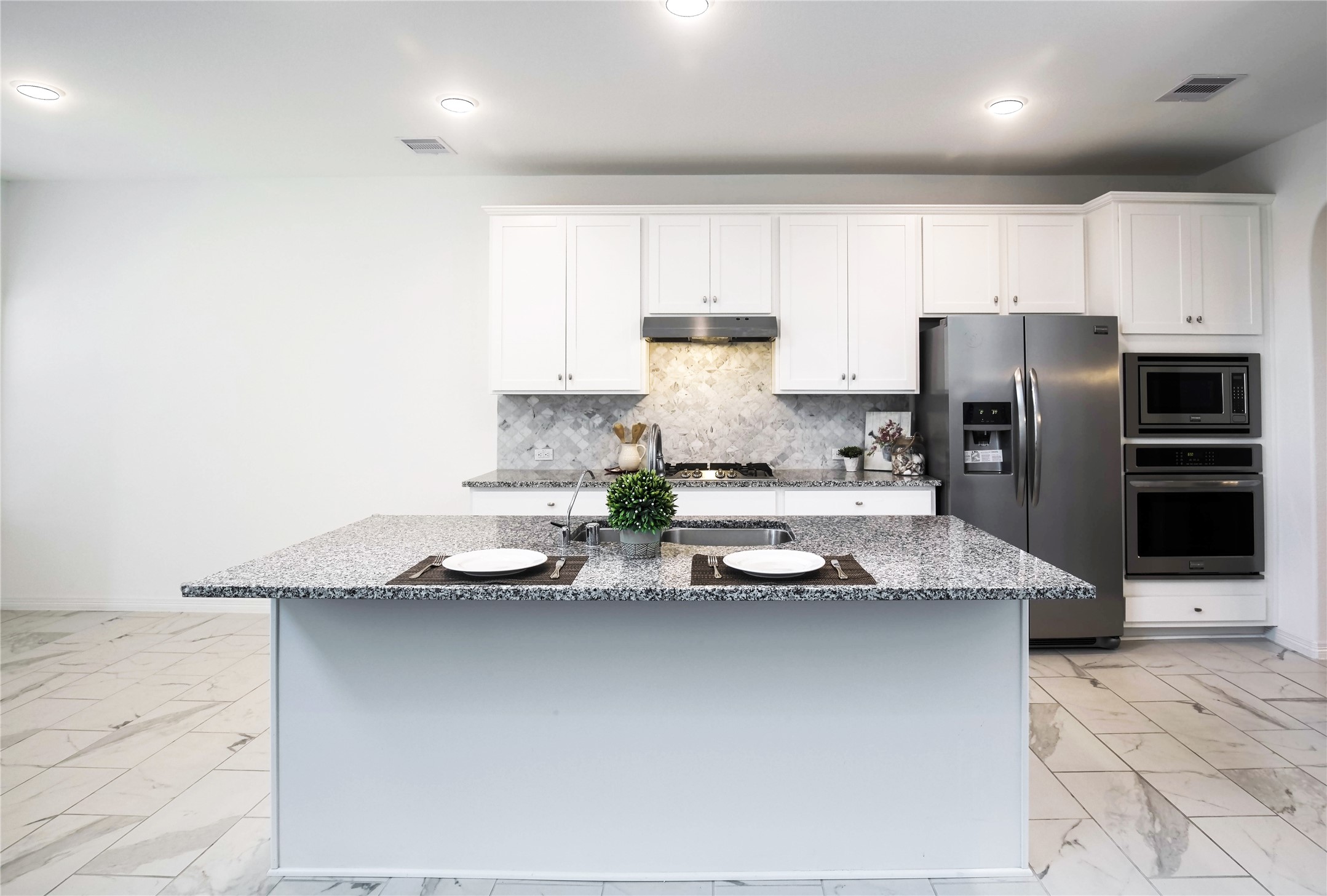 6307 Grand Drift Court Katy, TX 77494 - Photo 7 of 24 Gourmet Island Kitchen with Granite counter top, gas cook top, water filter system, water softener system,and tile floor. Refrigerator is included.