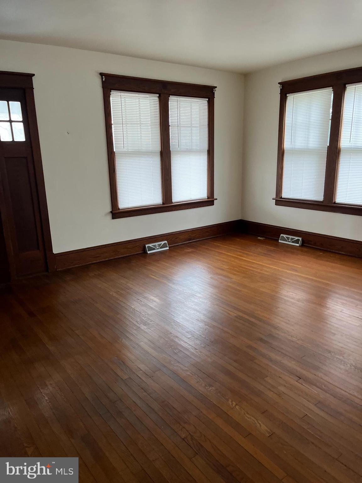 88 Main Street Biglerville, PA 17307 - Photo 4 of 13 an empty room with wooden floor and windows
