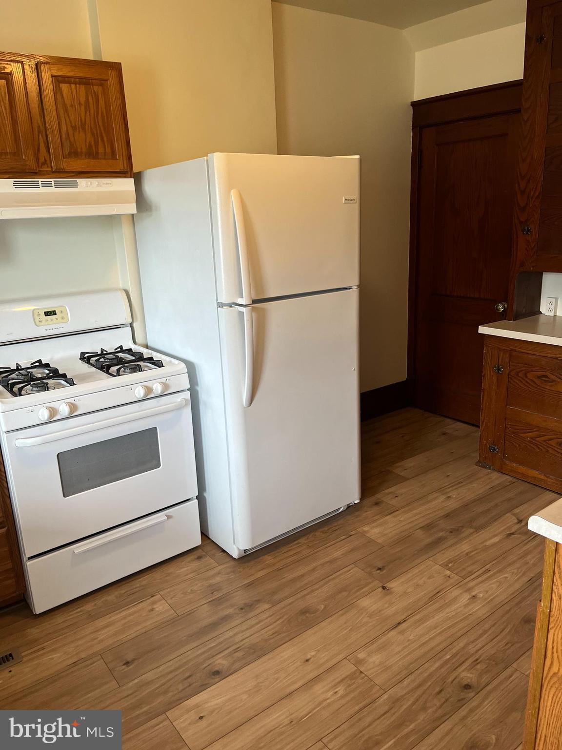 88 Main Street Biglerville, PA 17307 - Photo 7 of 13 a white refrigerator freezer and a wooden floor