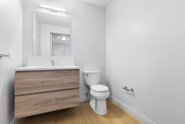 a bathroom with a sink toilet and mirror