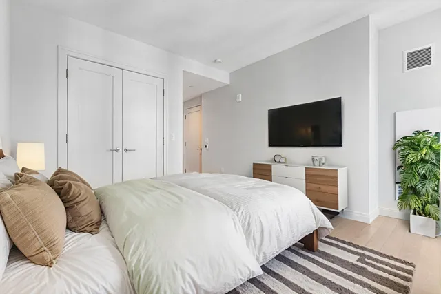 a bedroom with a bed and a flat screen tv