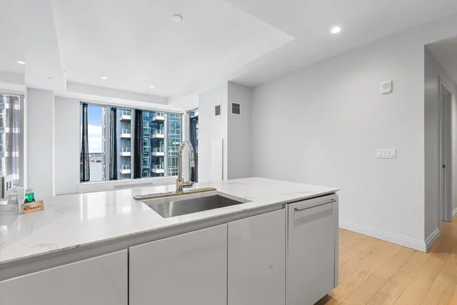 a kitchen with a sink and large window
