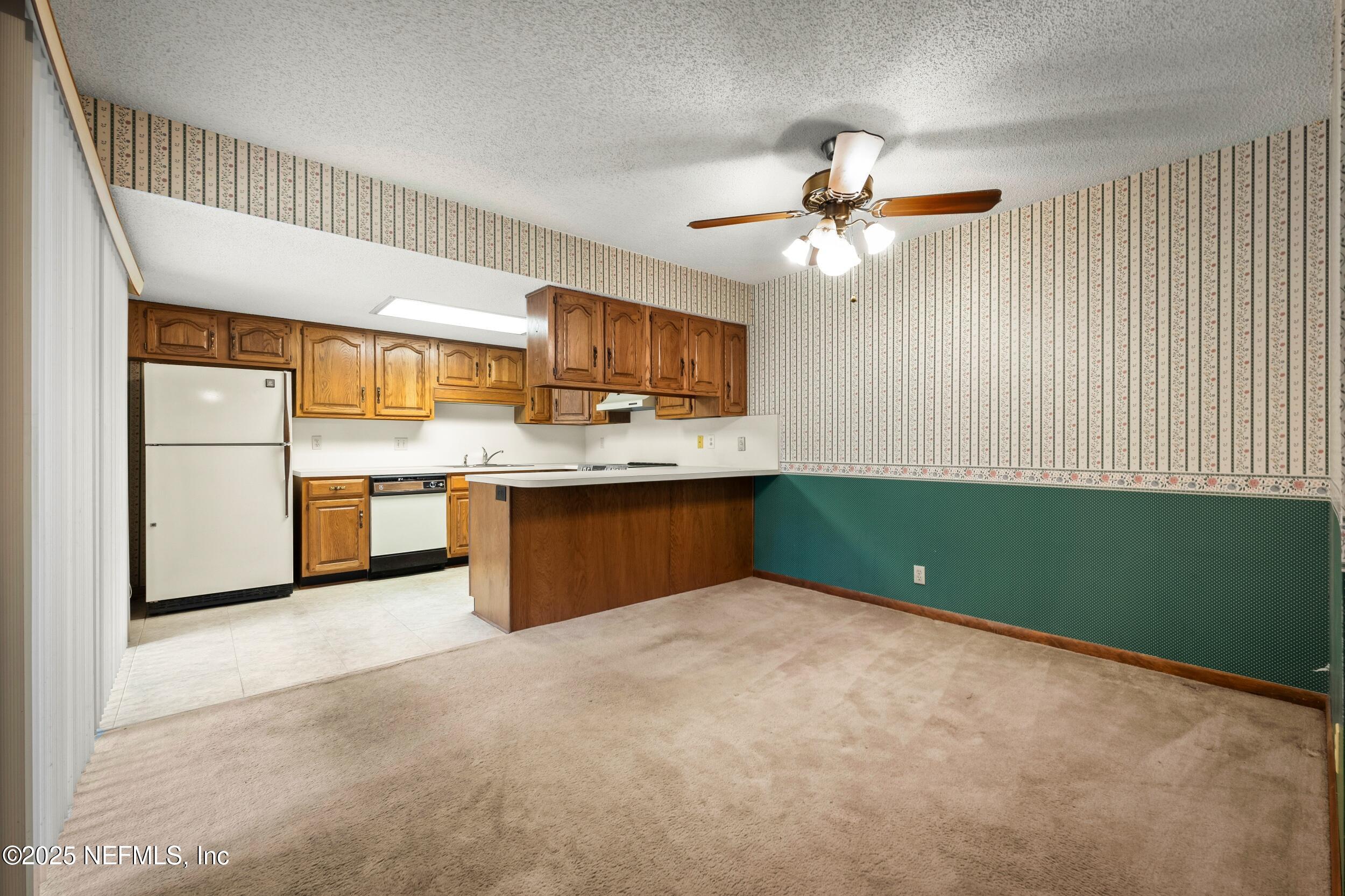 10349 Big Tree Terrace Jacksonville, FL 32257 - Photo 17 of 35 a kitchen with kitchen island a sink stainless steel appliances and cabinets