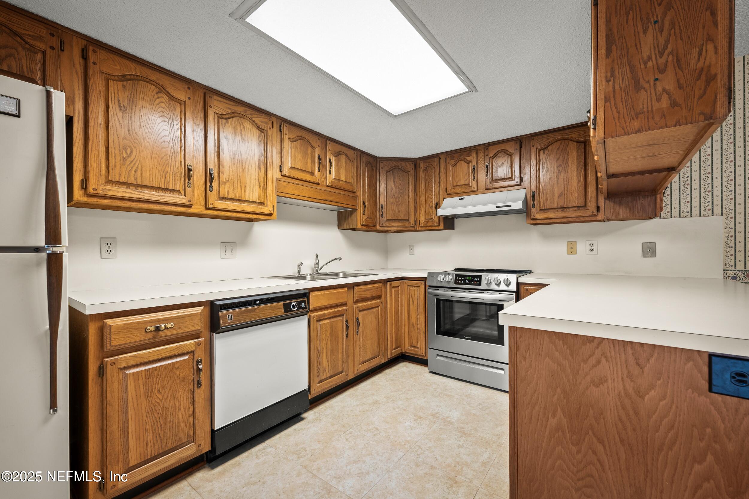 10349 Big Tree Terrace Jacksonville, FL 32257 - Photo 21 of 35 a kitchen with cabinets and stainless steel appliances
