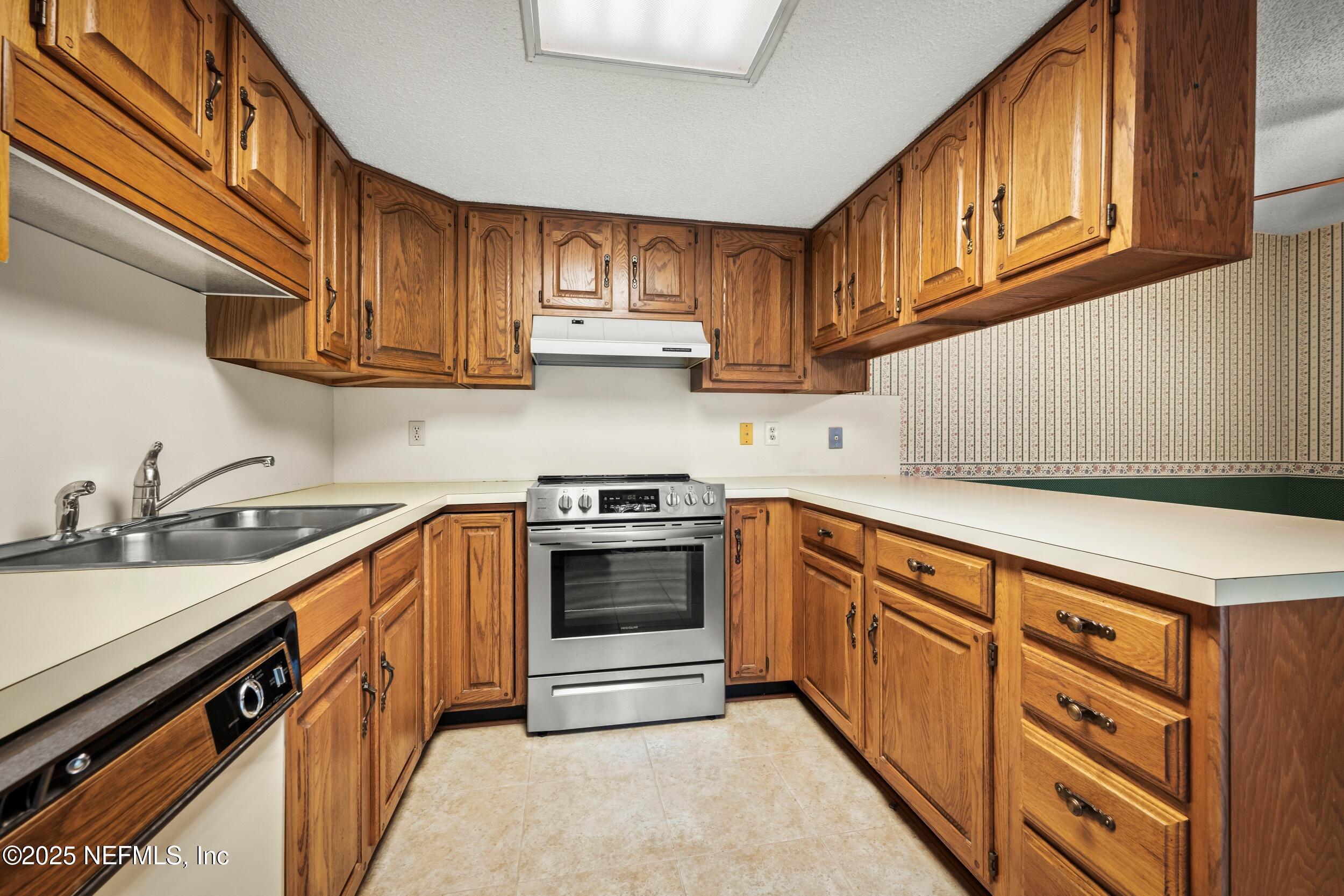 10349 Big Tree Terrace Jacksonville, FL 32257 - Photo 22 of 35 a kitchen with stainless steel appliances granite countertop a sink and cabinets