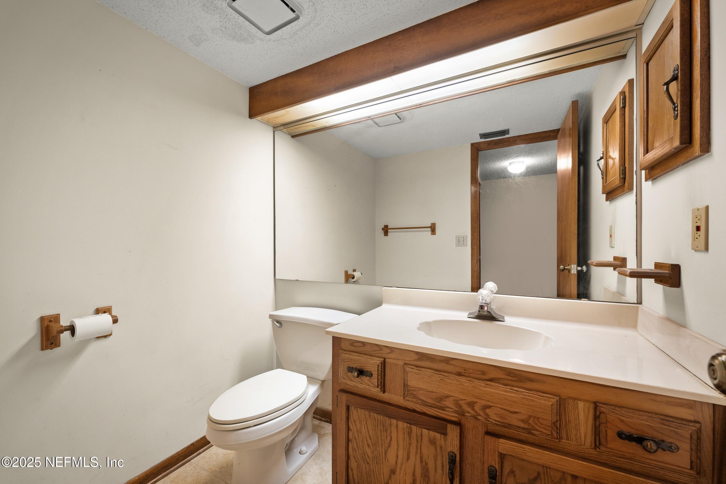 10349 Big Tree Terrace Jacksonville, FL 32257 - Photo 25 of 35 a bathroom with a sink and a toilet