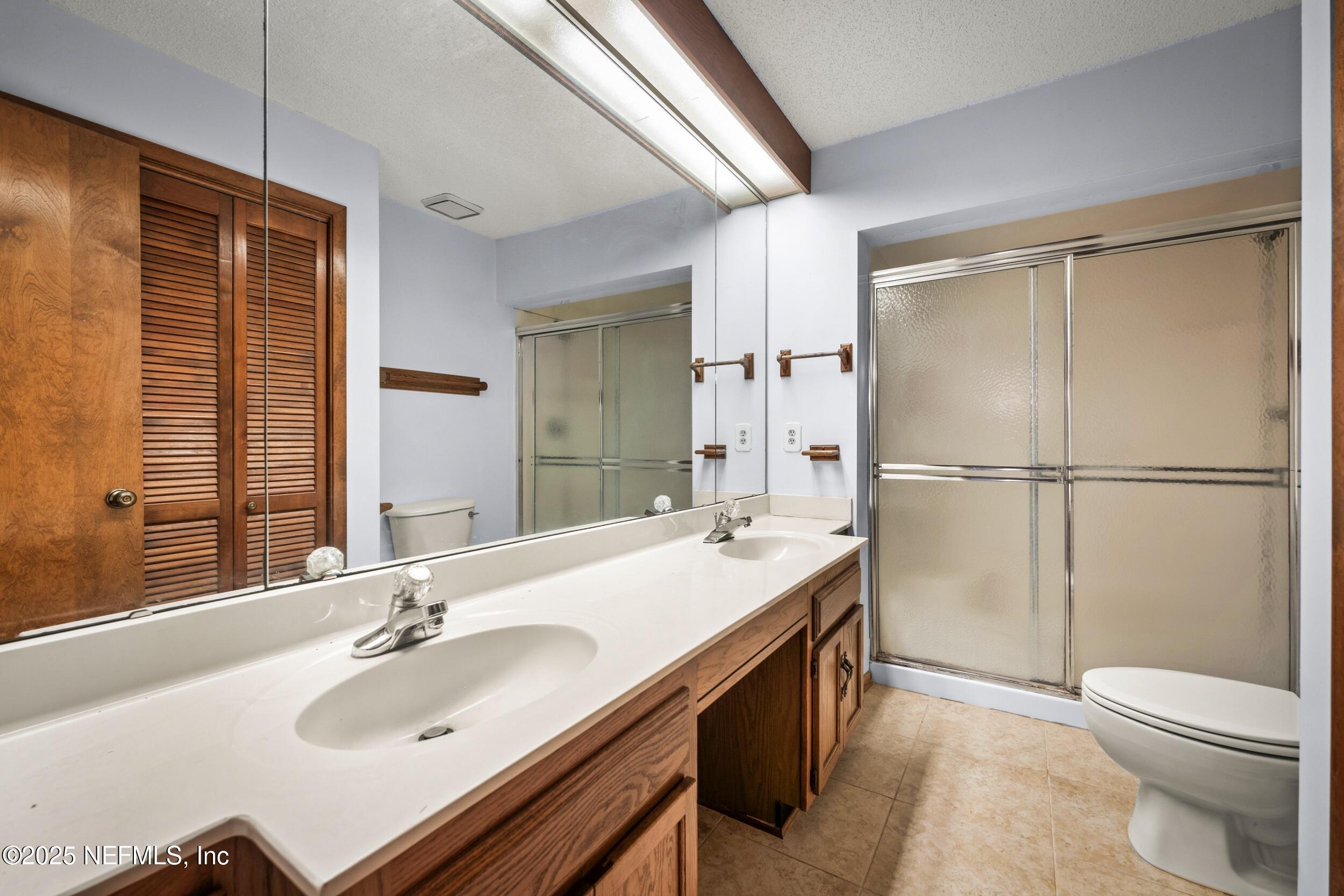 10349 Big Tree Terrace Jacksonville, FL 32257 - Photo 30 of 35 a bathroom with a sink double vanity granite tub shower and a mirror