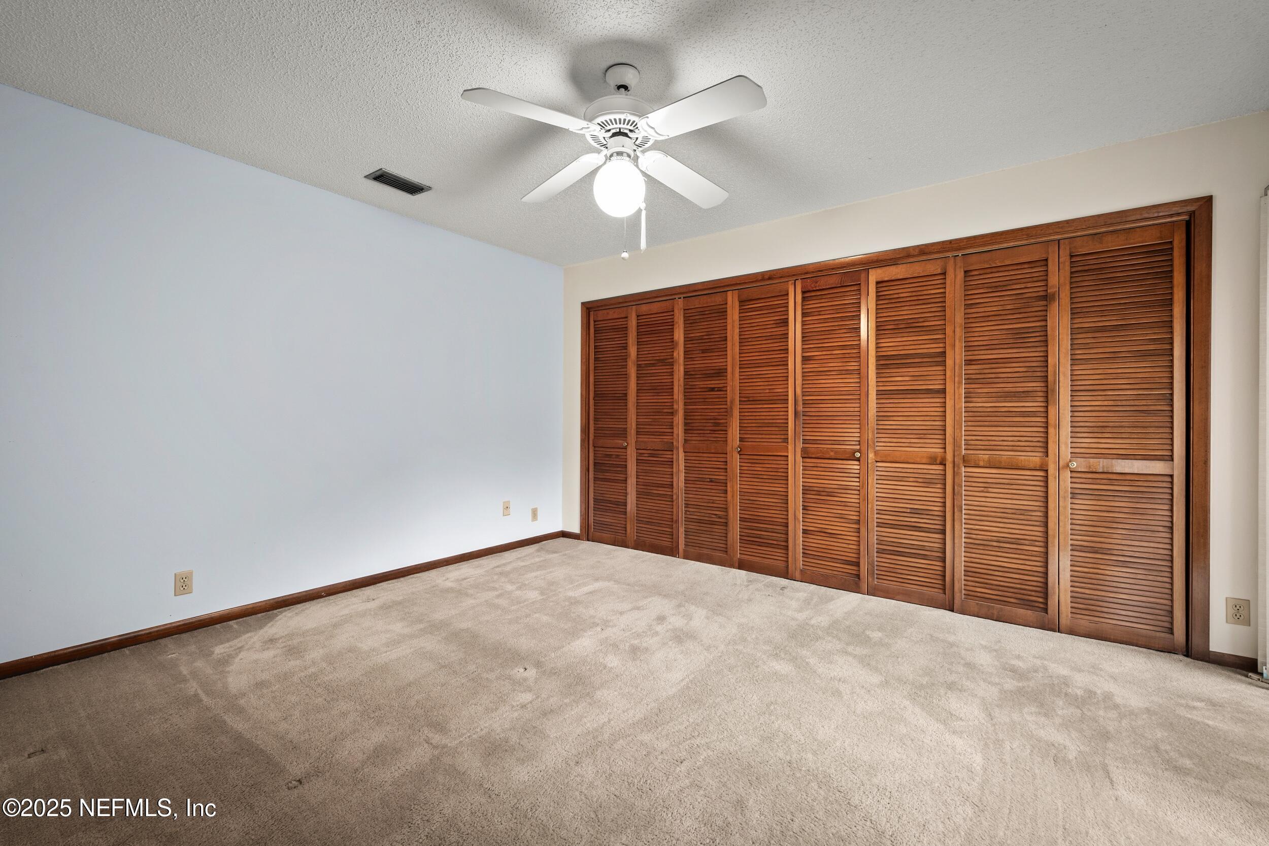 10349 Big Tree Terrace Jacksonville, FL 32257 - Photo 32 of 35 a view of an empty room with a ceiling fan