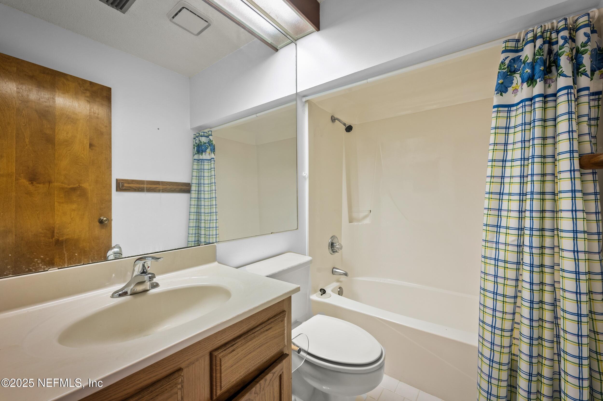 10349 Big Tree Terrace Jacksonville, FL 32257 - Photo 35 of 35 a bathroom with a granite countertop sink toilet a mirror and shower