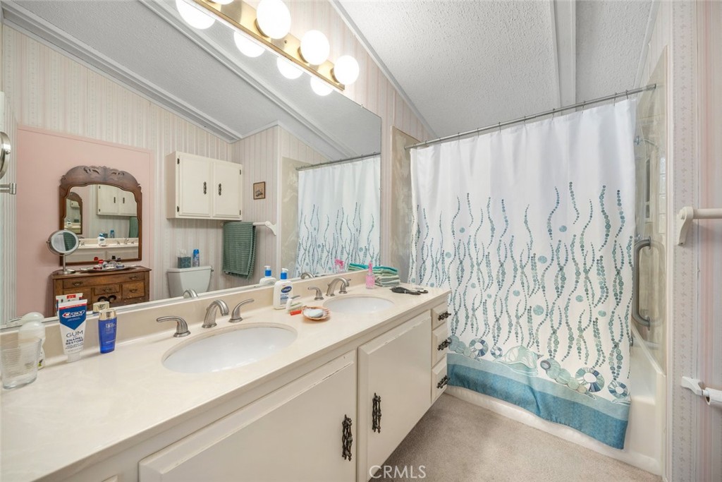 132 Quail Way Avila Beach, CA 93424 - Photo 19 of 38 a bathroom with a double vanity sink and a mirror