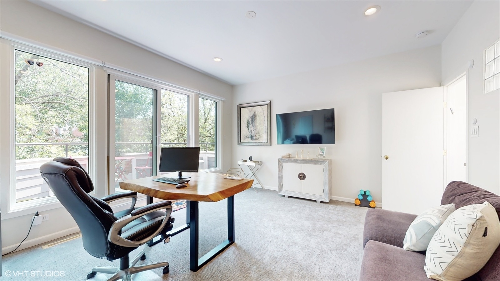 2216 North Wayne Avenue Chicago, IL 60614 - Photo 23 of 40 a living room with furniture a flat screen tv and a floor to ceiling window