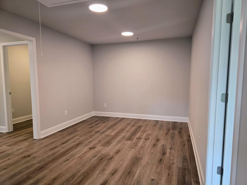 4240 Cavalier Way Duluth, GA 30097 - Photo 34 of 46 a view of an empty room with wooden floor