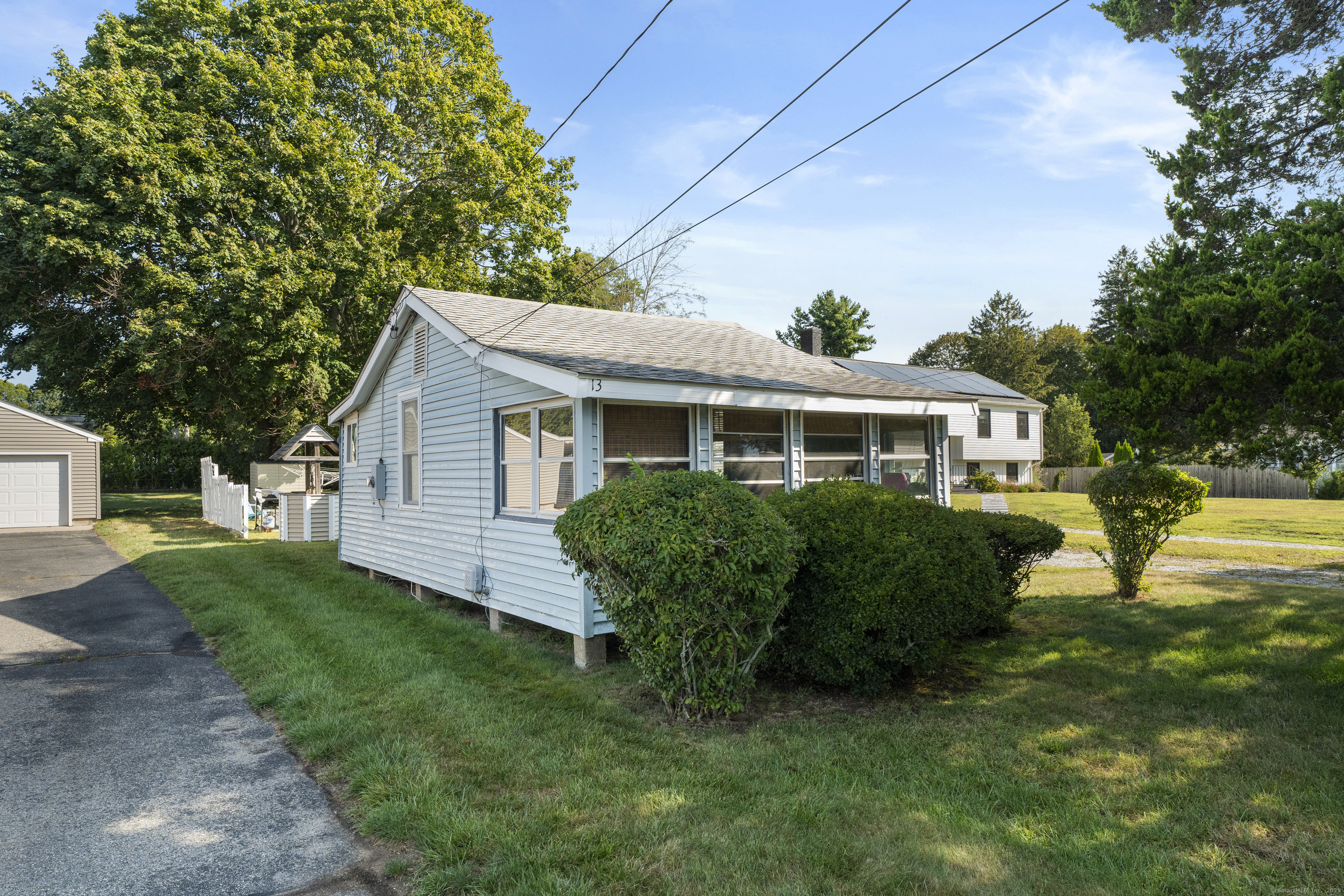 13 College Street Old Saybrook, CT 06475 - Photo 2 of 23 a front view of house with yard and green space